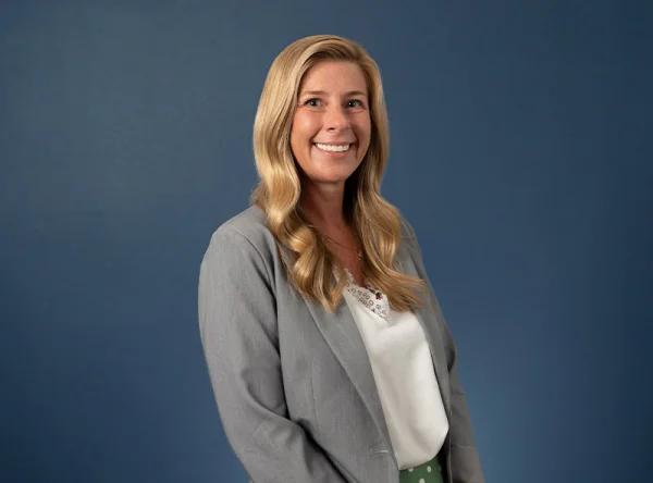 a woman standing in front of a blue background