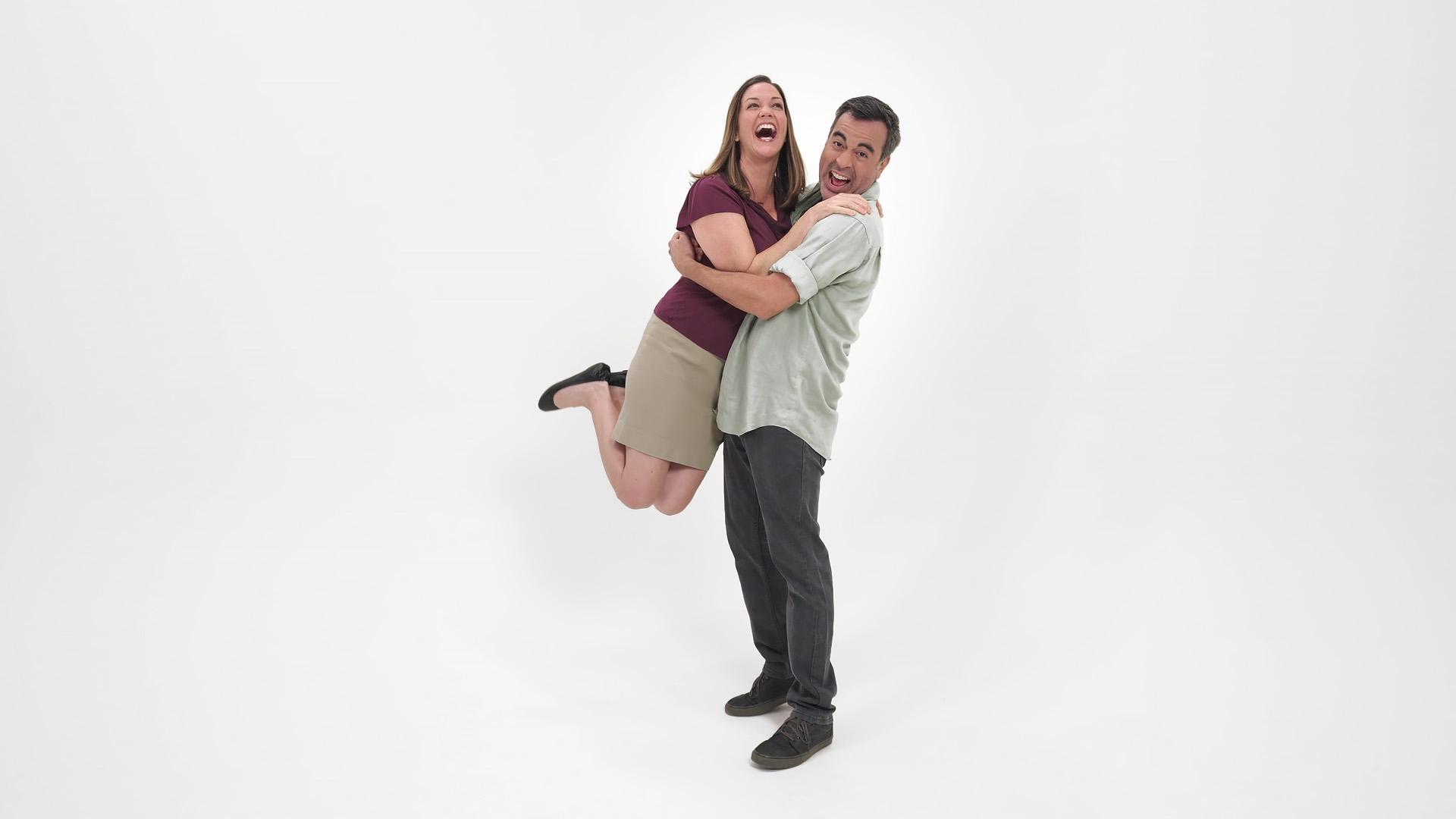A Middle age couple jumping for joy.