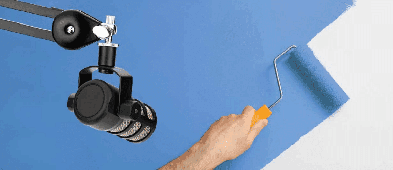A person is using a paint roller to paint a wall