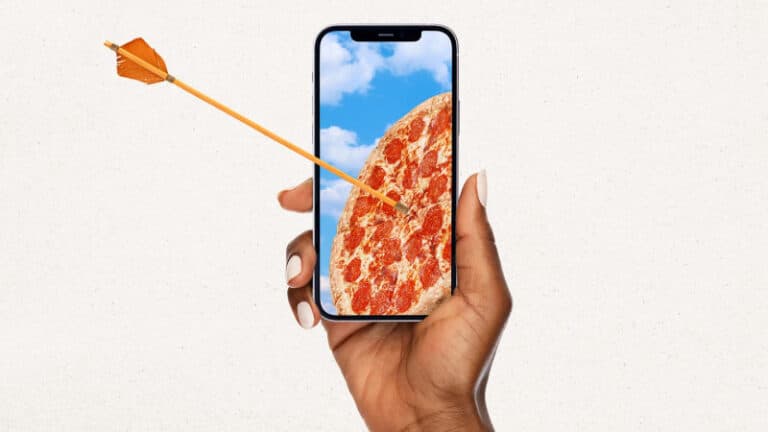 a hand holding a phone with a picture of a pizza on it