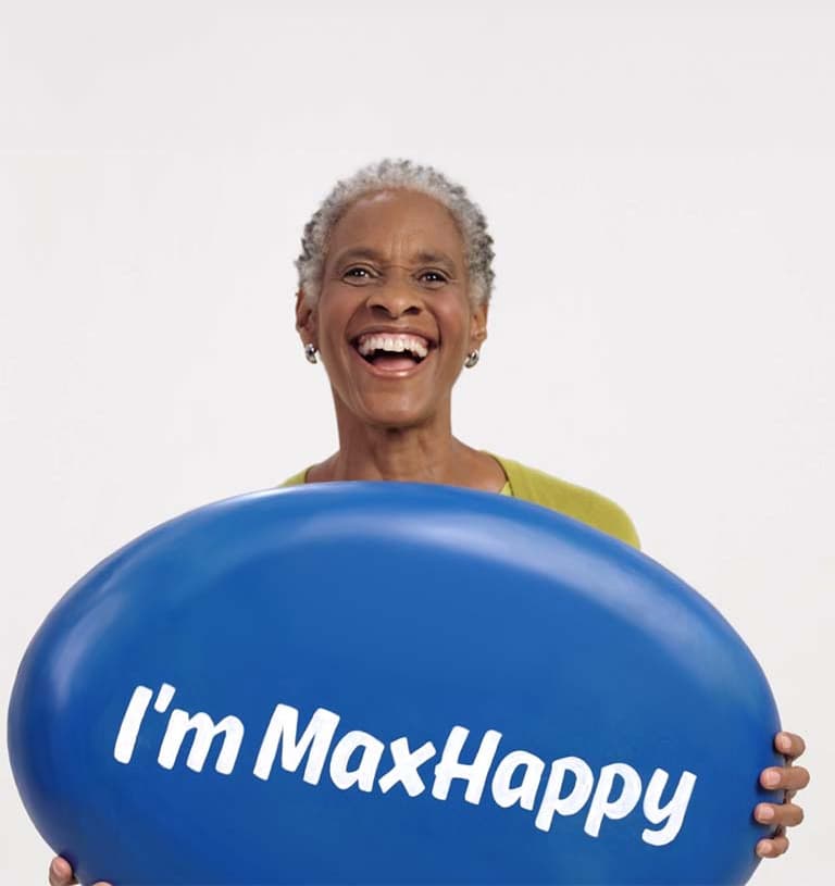 Elderly Woman Holding a Sign labeled "I'm MaxHappy"