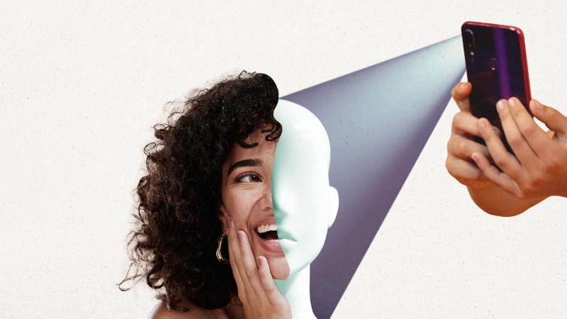 A cell phone projecting beam of on a woman, revealing a mannequin underneath.