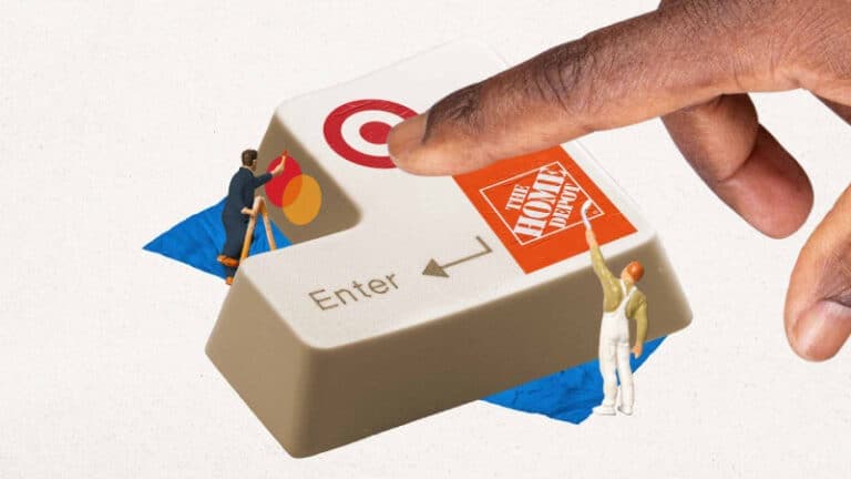An keycap for the "Enter" button under renovation by miniature construction workers who are painting the "Mastercard", "Target", and "Home Depot" logos.