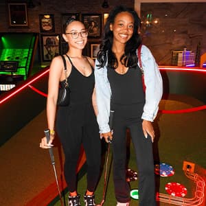 Two girls enjoying mini-golf