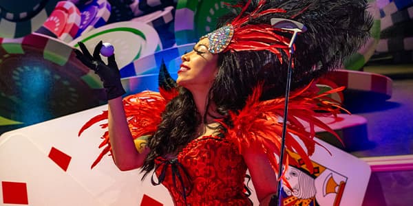 Las Vegas Showgirl admiring a golf ball and holding a golf club