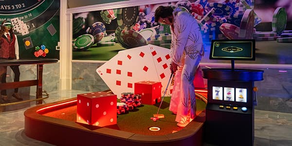 Elvis playing mini-golf with large cards and dice